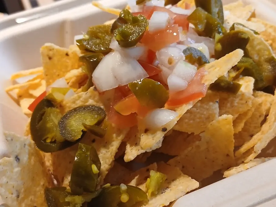 Melted cheese covering the surface of the nachos