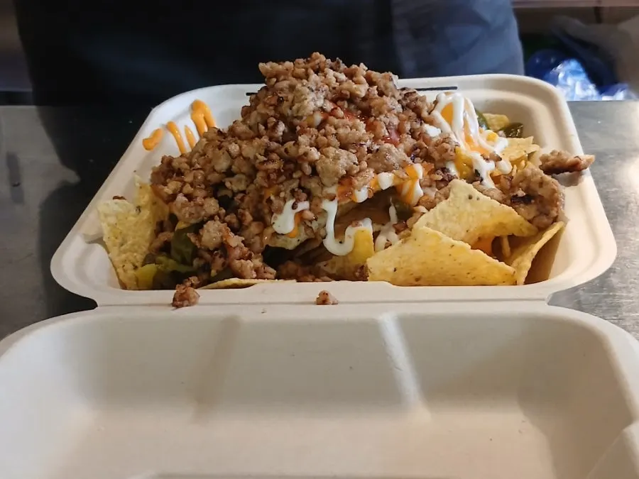 Close-up of nachos with cheese and meat toppings mixed together