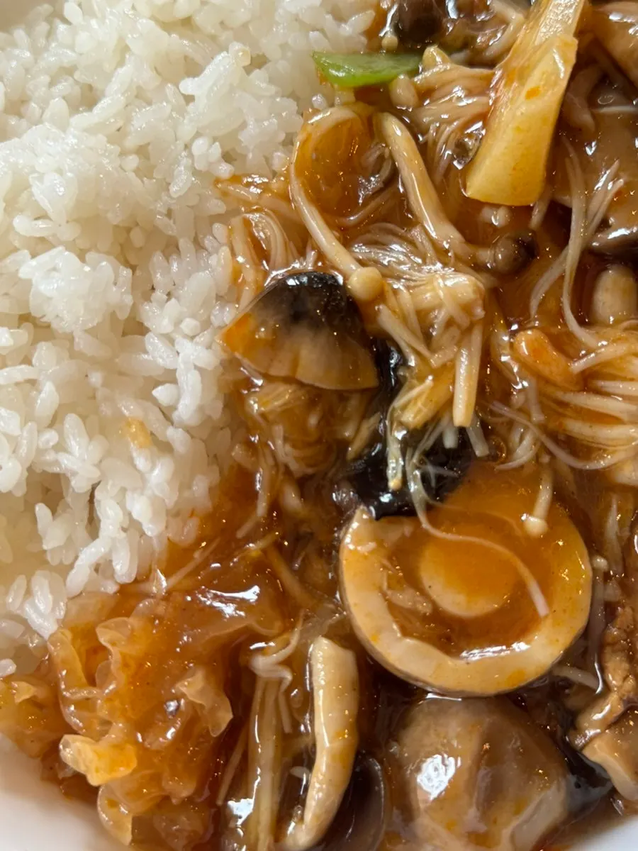 Close-up of mixed mushroom rice bowl stir-fried in signature sauce
