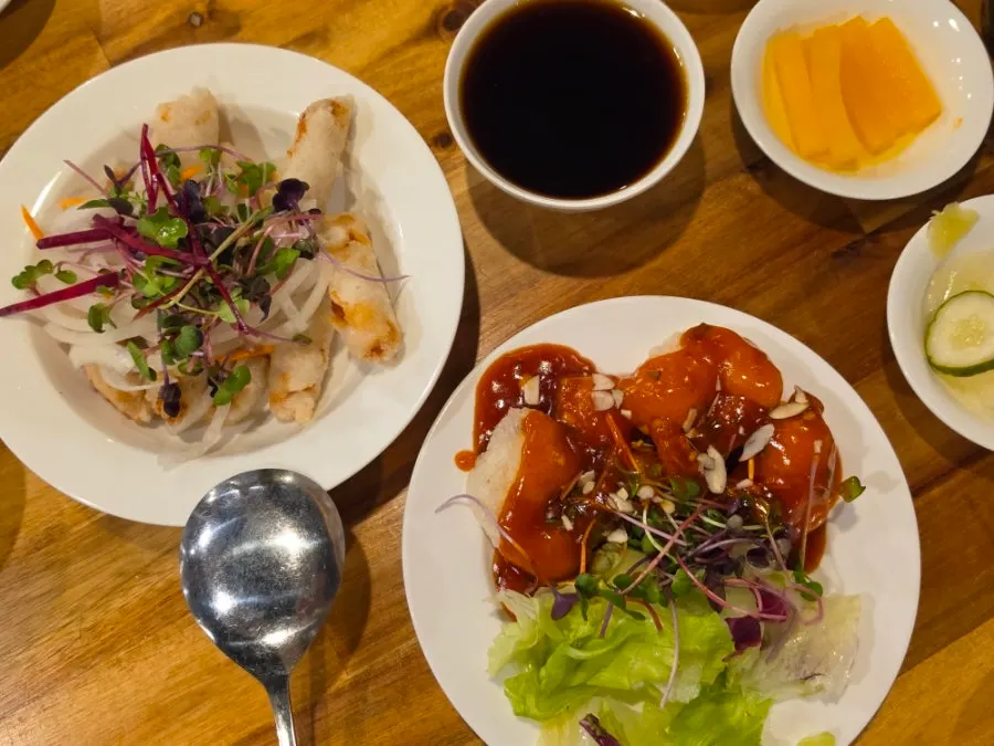 A piece of sweet and sour pork dipped in sauce