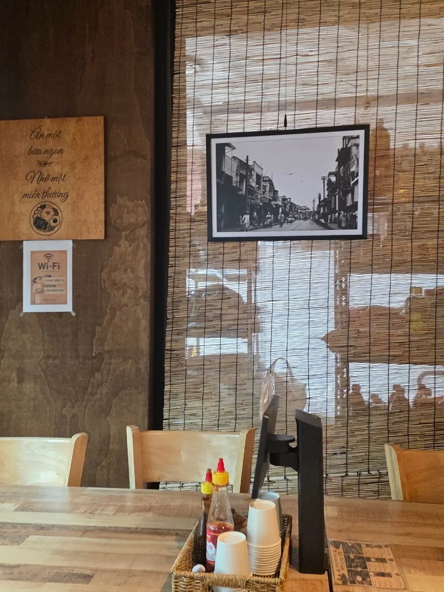 Madam Hao interior decorated with blinds, plants, and Vietnamese decor