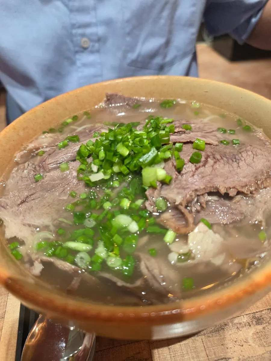 Madam Hao's beef brisket pho topped with scallions instead of cilantro