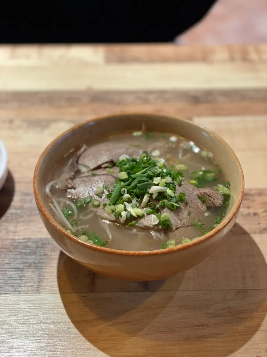 Close-up of the clear broth in the beef brisket pho