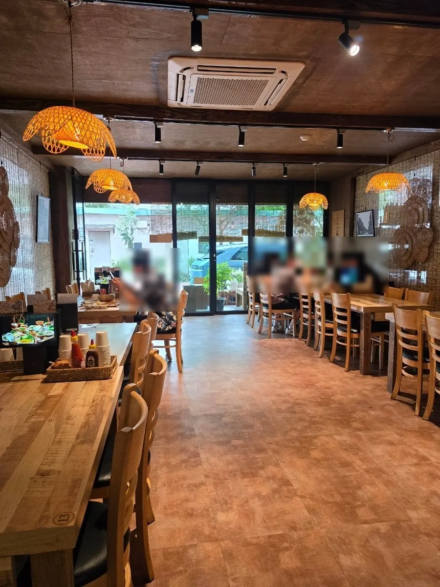 Madam Hao's interior with wood tables and warm lighting