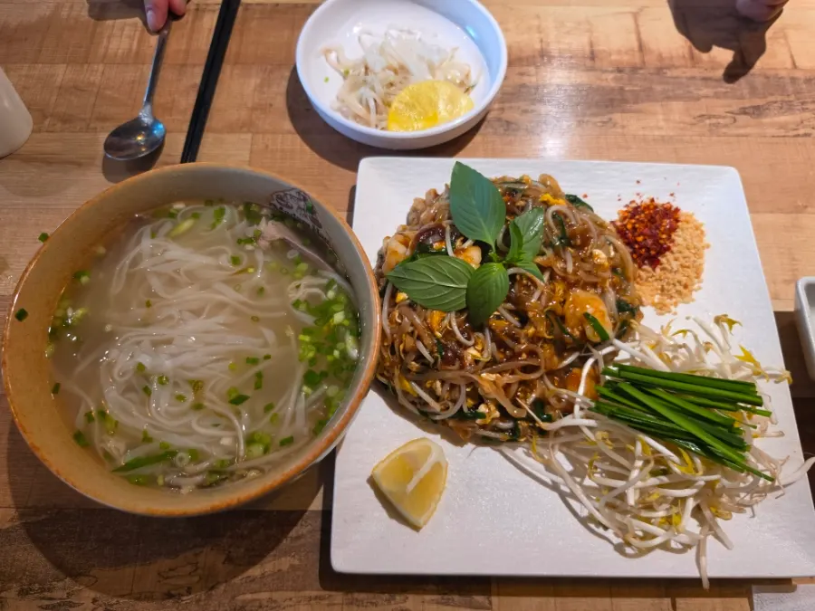 Pad thai served with bean sprouts, chives, and crushed peanuts