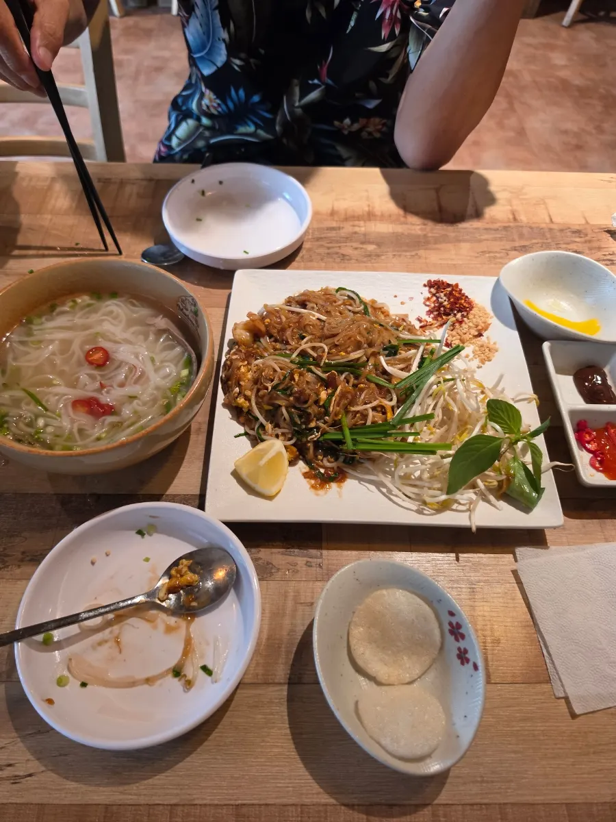 Lunch spread with pho and pad thai together