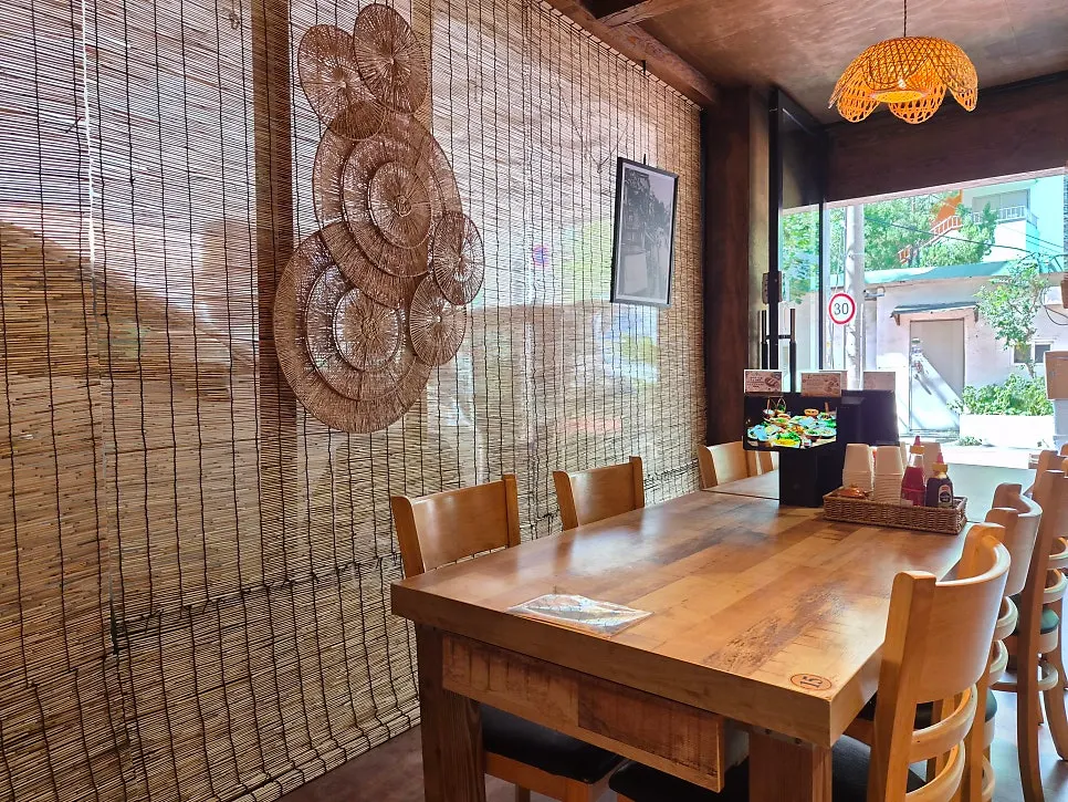 Corner of the restaurant decorated with bamboo props and lighting