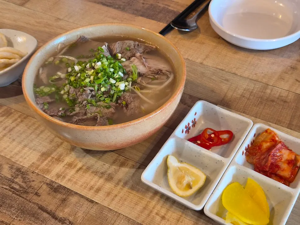 A bowl of brisket pho piled generously with meat