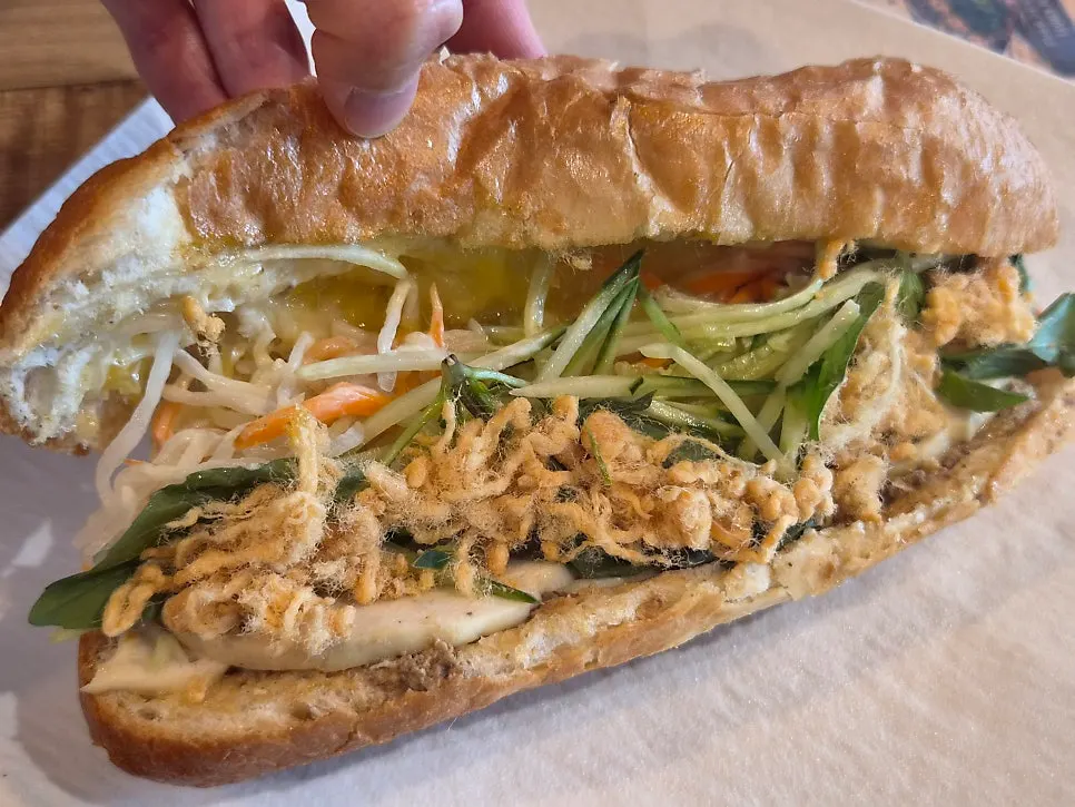 Cross-section of the rice baguette banh mi packed with meat and vegetables
