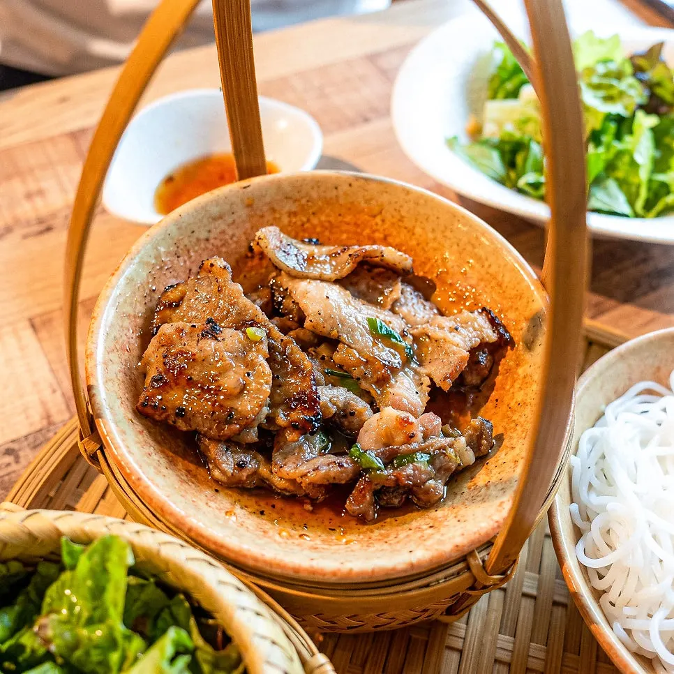Picking up a piece of bun cha pork