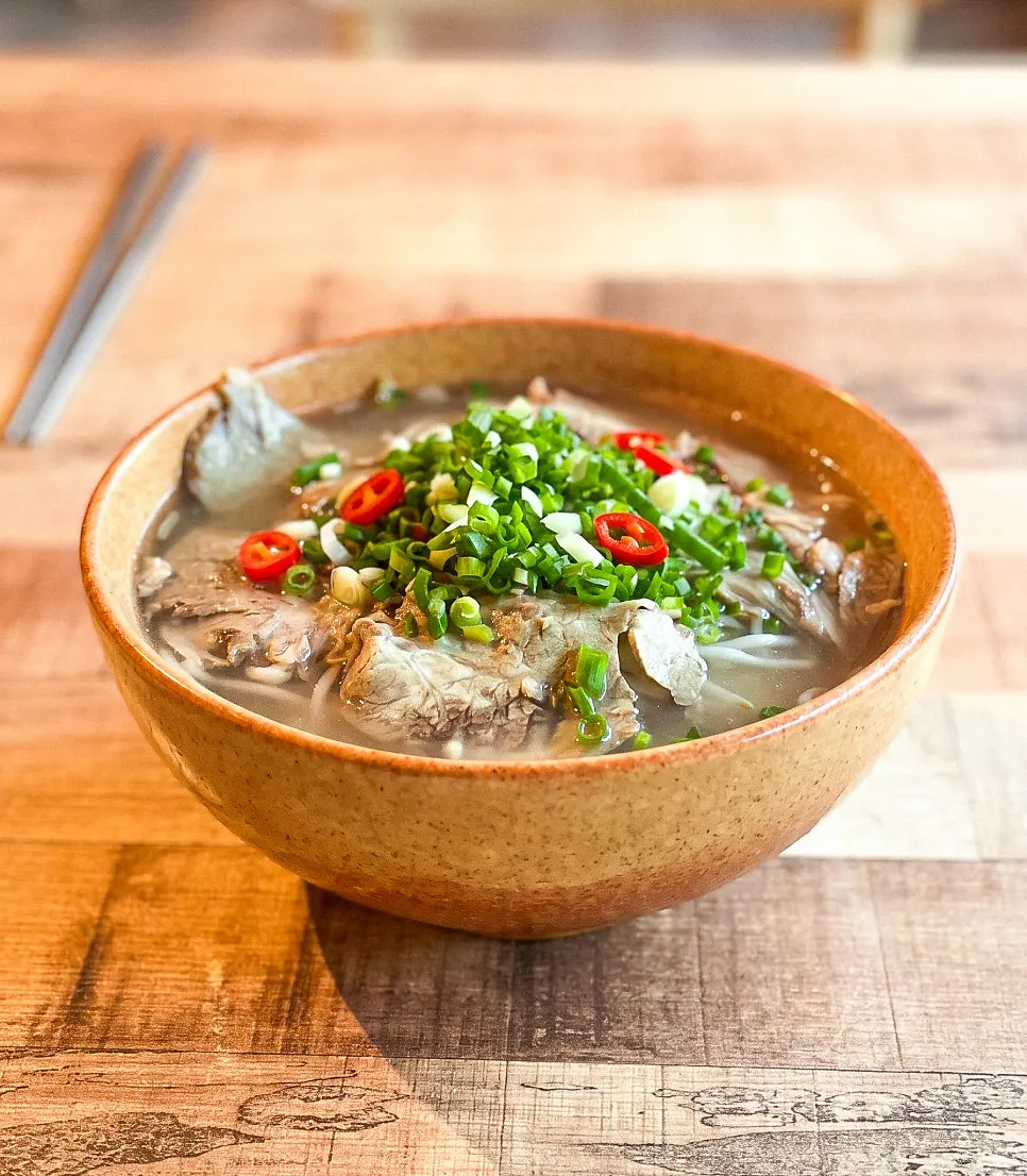 Beef brisket pho topped with scallions
