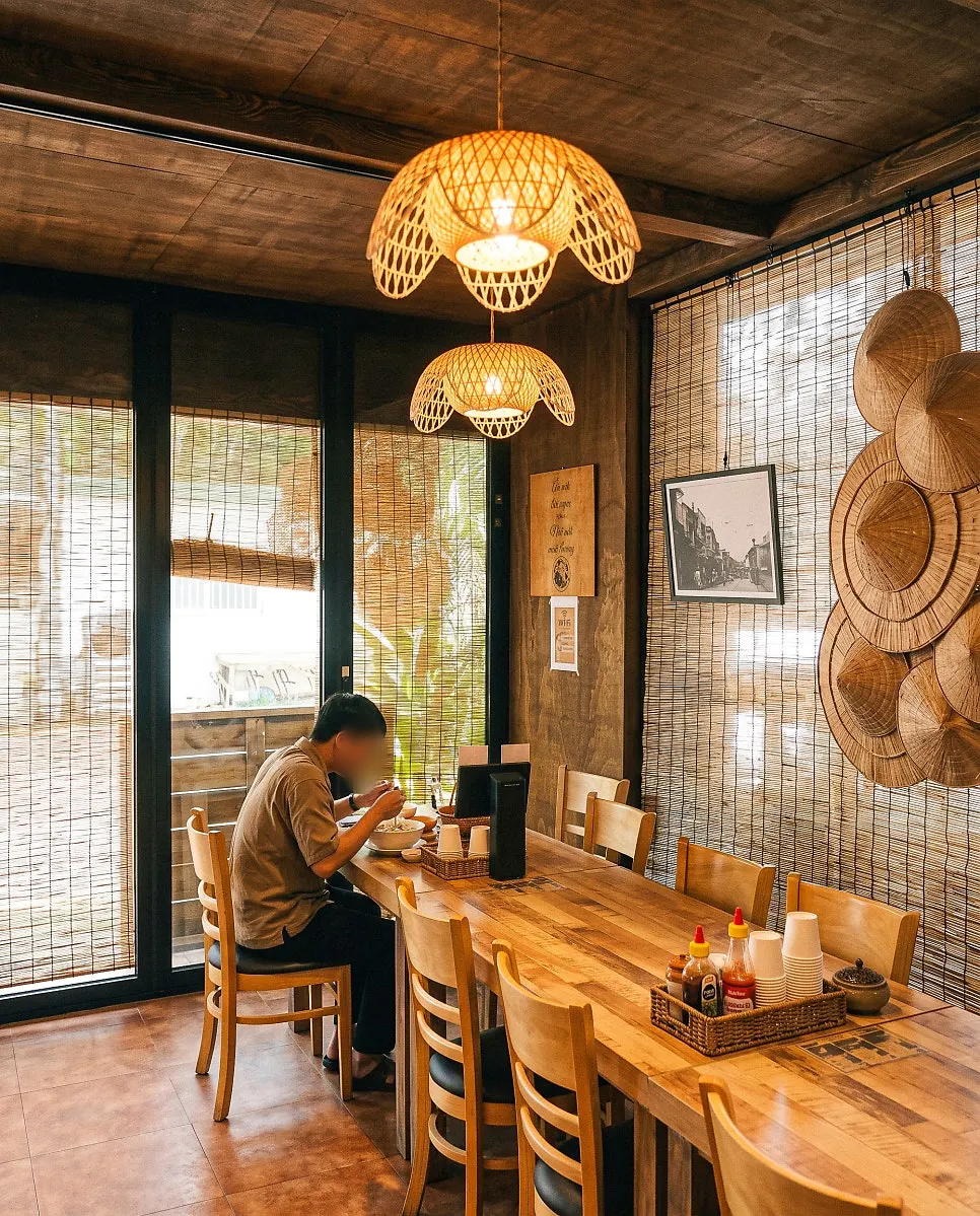 Seating at Madam Hao under bamboo lighting