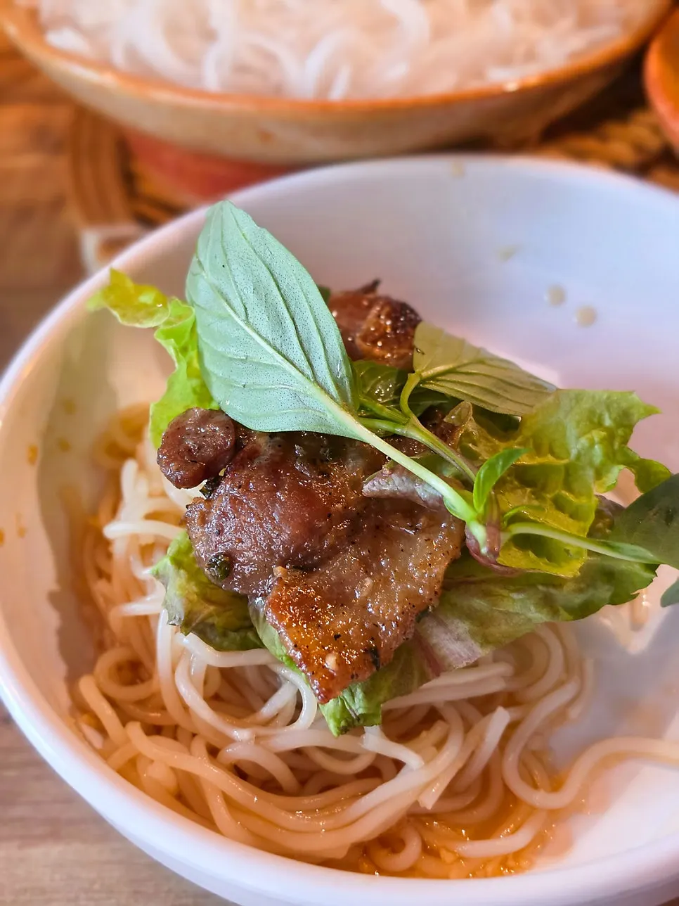 Bun cha pork soaking in nuoc mam sauce