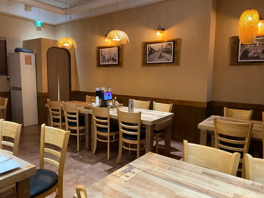 Seating area with straw lighting and wood-tone tables