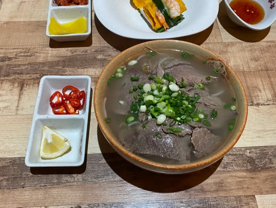 A steaming bowl of beef brisket pho