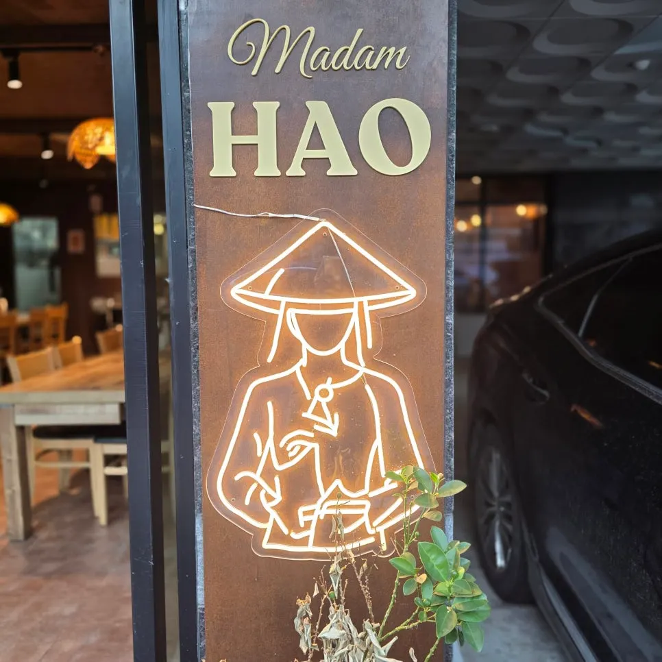 Neon sign of a woman in a traditional Vietnamese hat