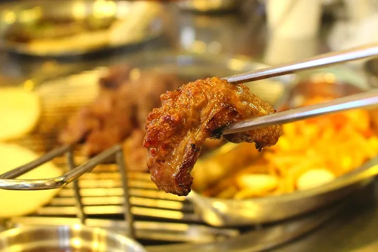 Marinated galbisal grilling over charcoal