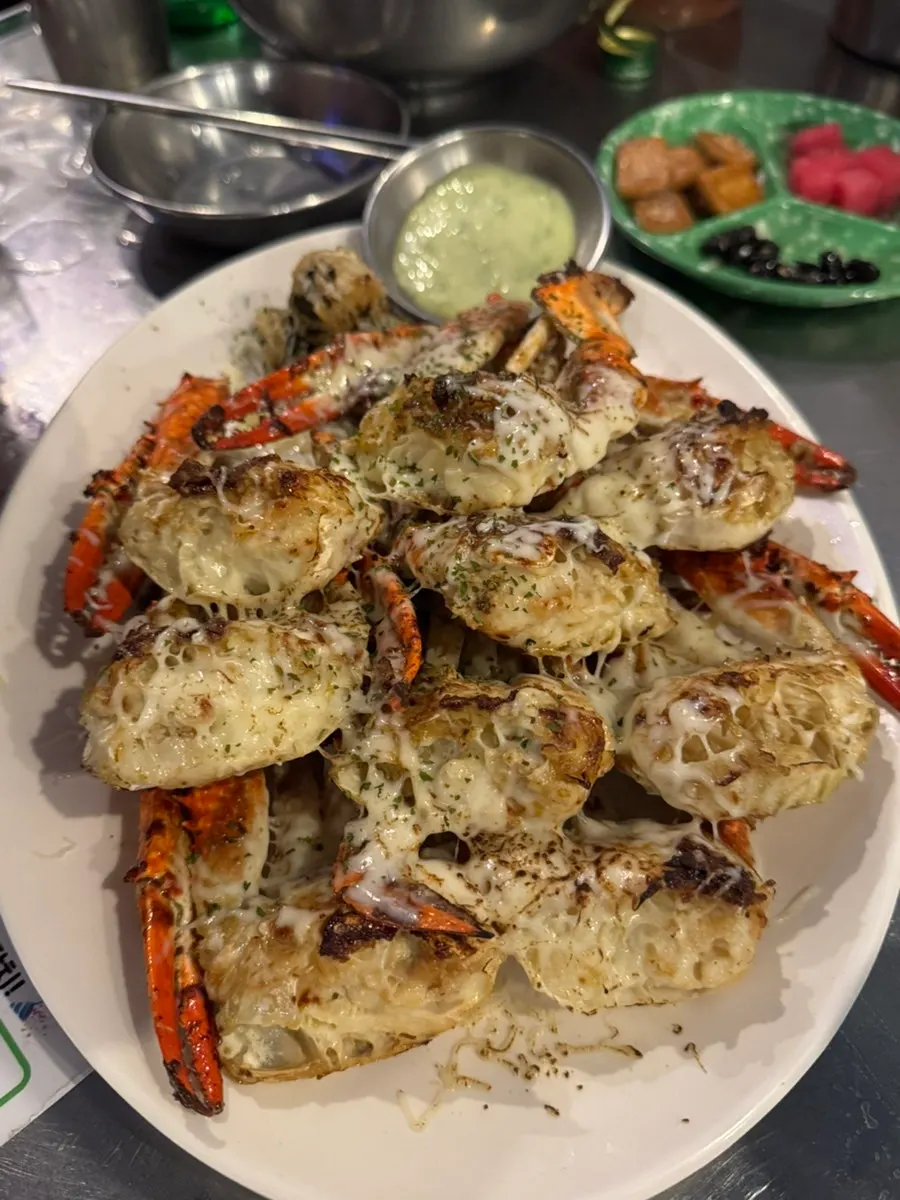 Close-up of the cheese-topped butter grilled crab