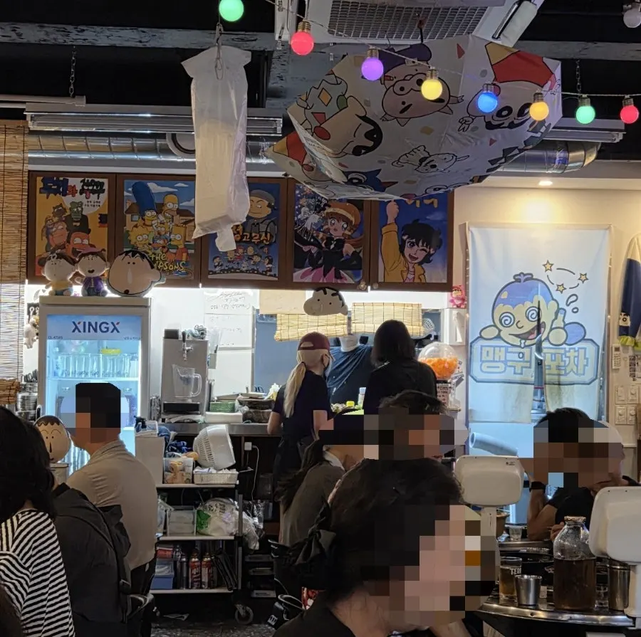 Interior of the pocha with retro props and a chalkboard