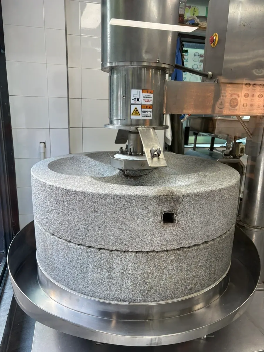 Large stone mill placed in front of the restaurant