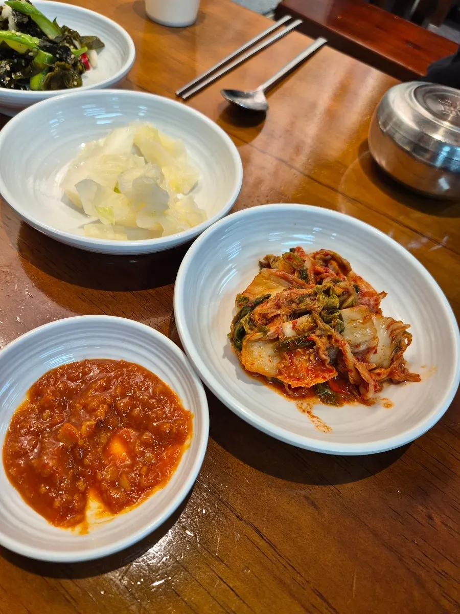 A bowl of sundubu topped with soy sauce seasoning
