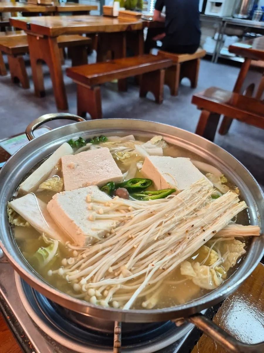 Wrapping bossam pork with pickled radish and plain tofu