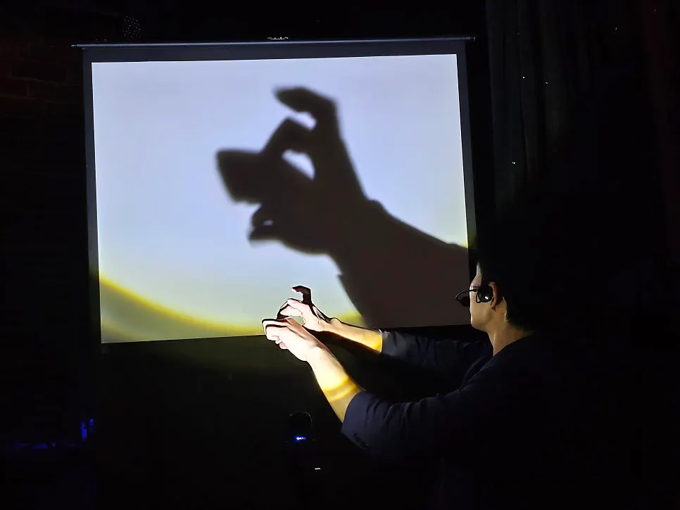 Wide shot of the magic show in the small theater