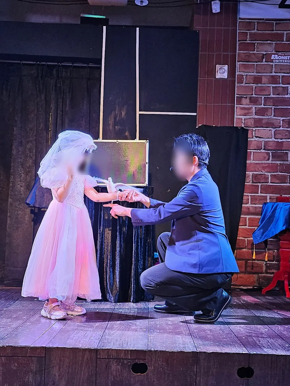 A child audience member participating on stage