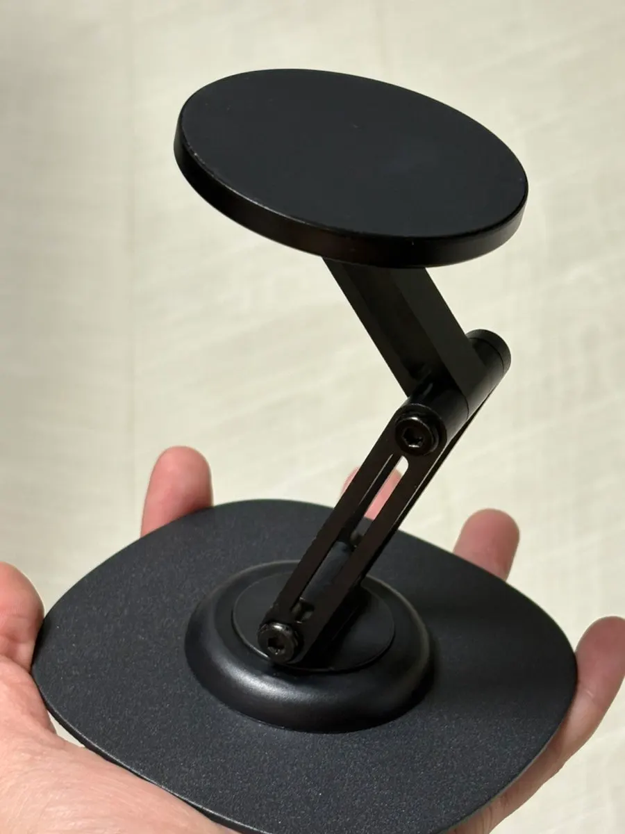 Metal-black phone stand on a desk