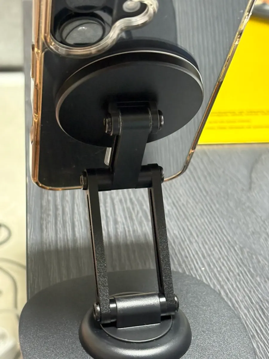 Magnetically secured phone stand in use