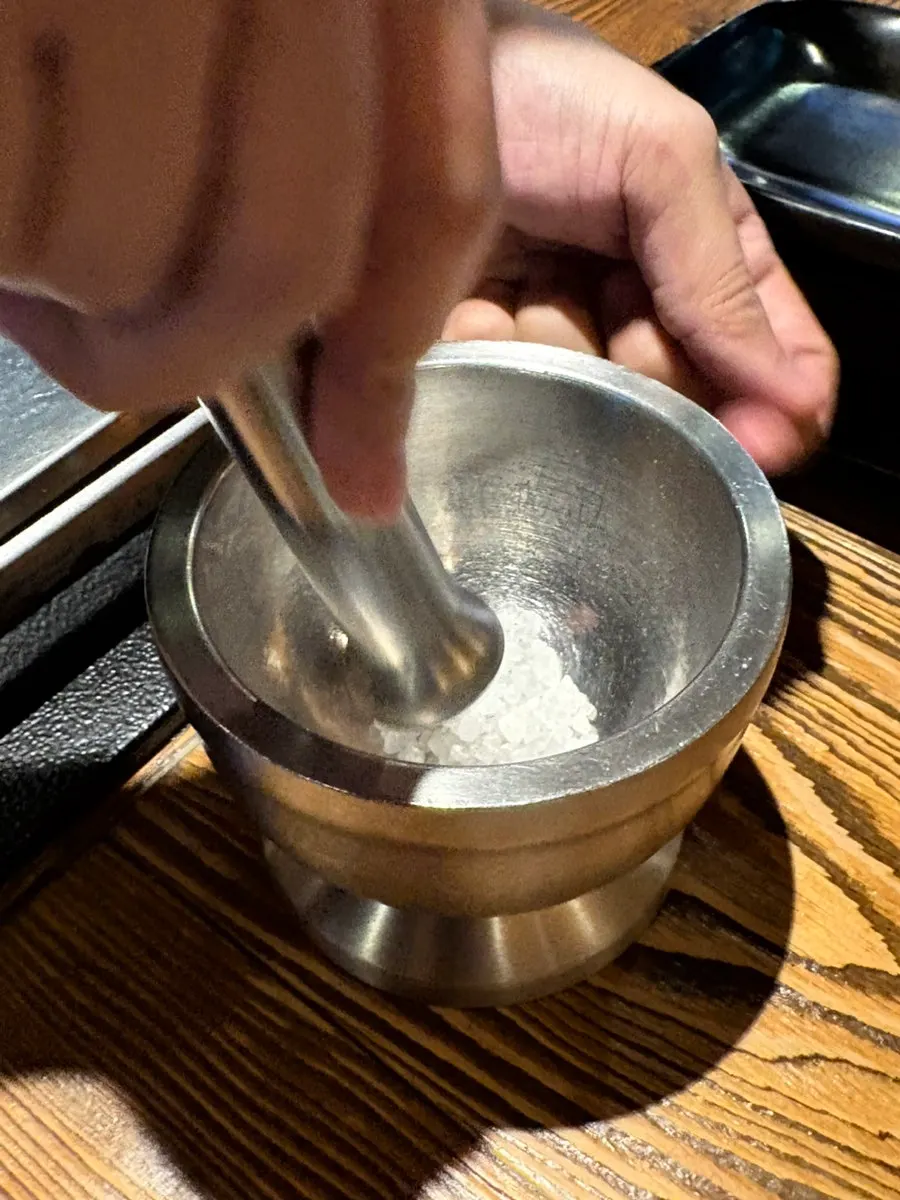 Server grilling meat directly
