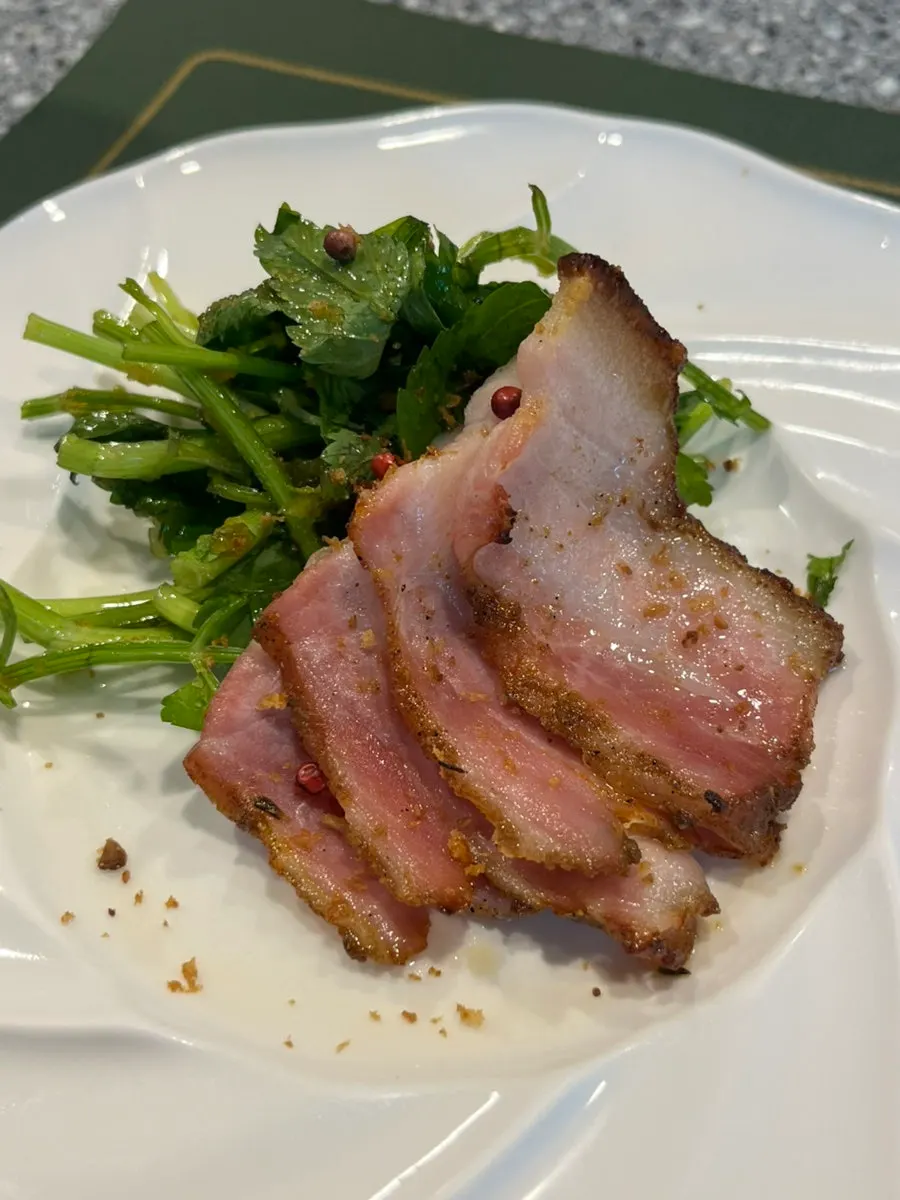 Plate of handmade bacon and seasoned minari