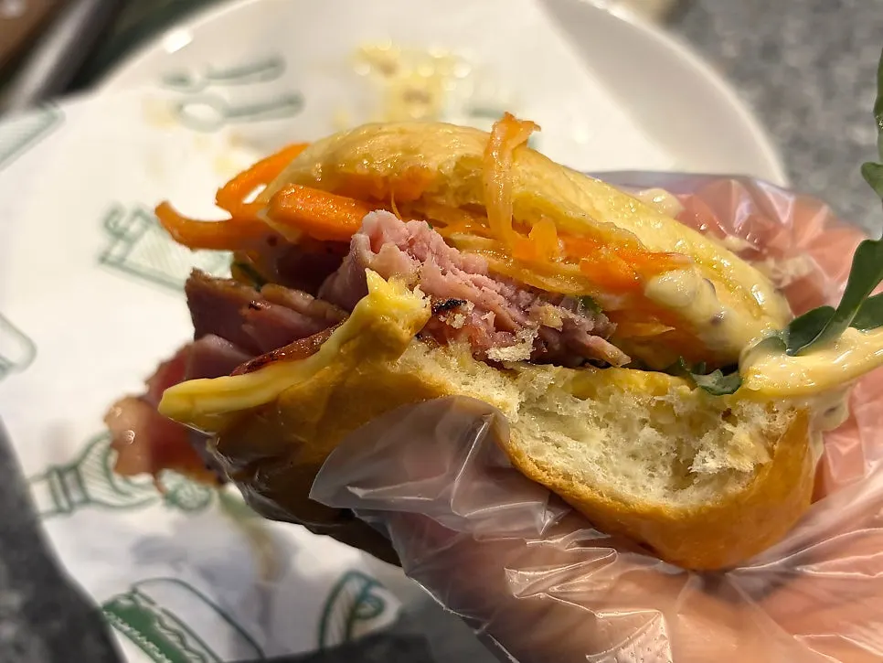 Signature burger with jambon, arugula, and carrot rapee