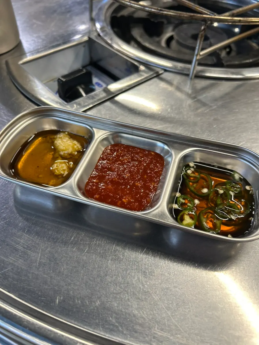 Individual dish of dipping sauce and side items