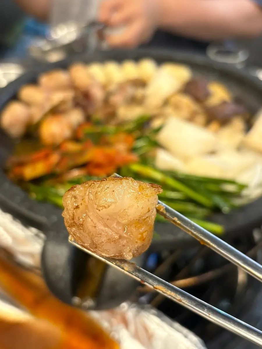 A piece of gopchang wrapped in a perilla leaf