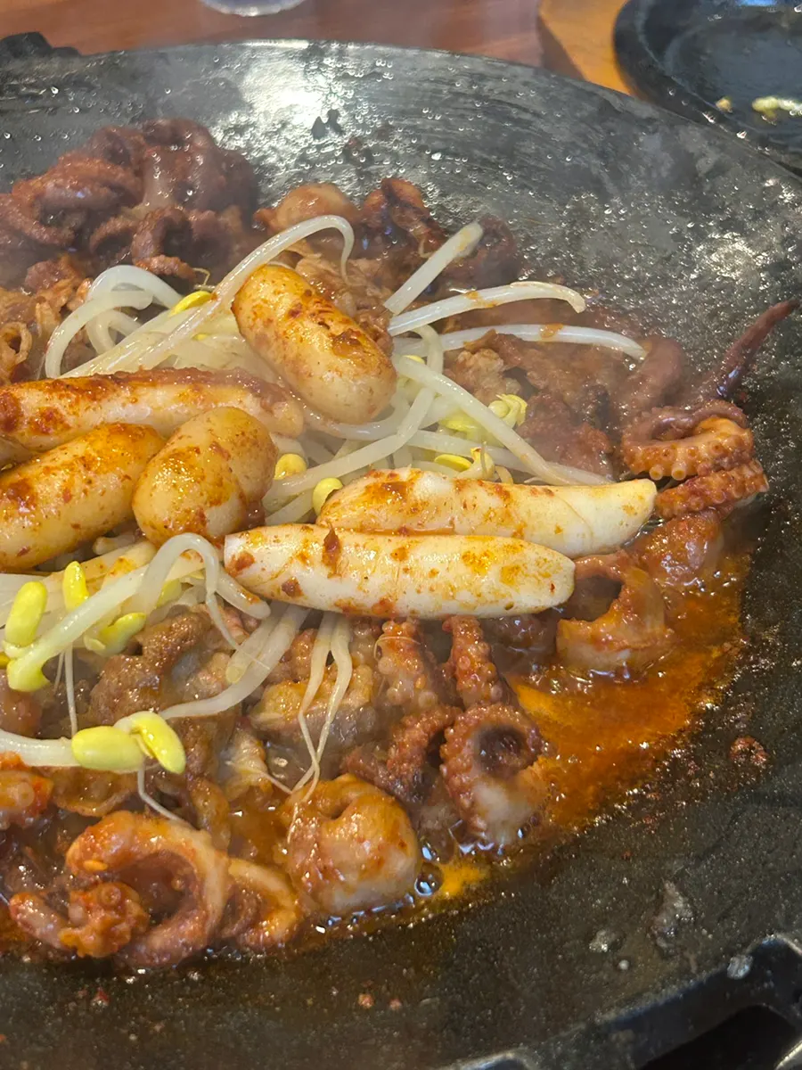 Cooked jjukkumi with bean sprouts and rice cakes