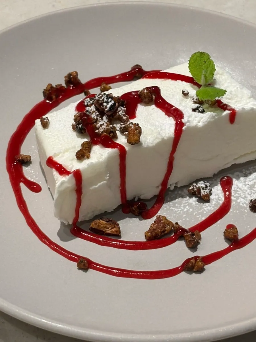 Dessert with nuts and berry sauce