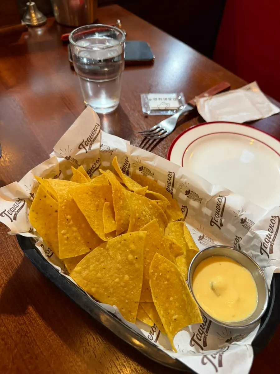 Basic nacho chips and cheese sauce served first