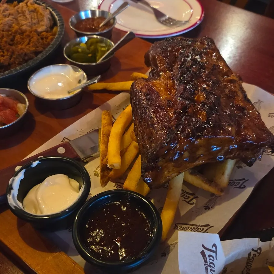 Ribs and fries placed next to the beer