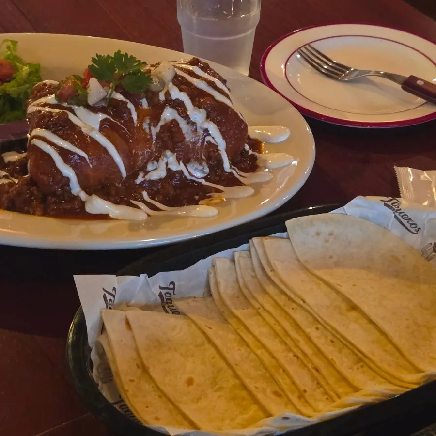 Team dinner table with tacos, ribs, and beer