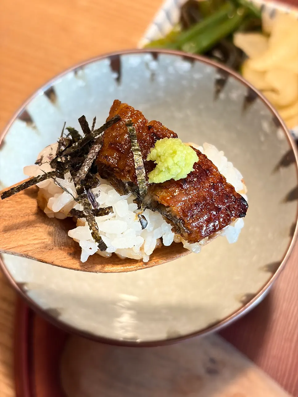 Step-two hitsumabushi topped with wasabi, scallions, and seaweed