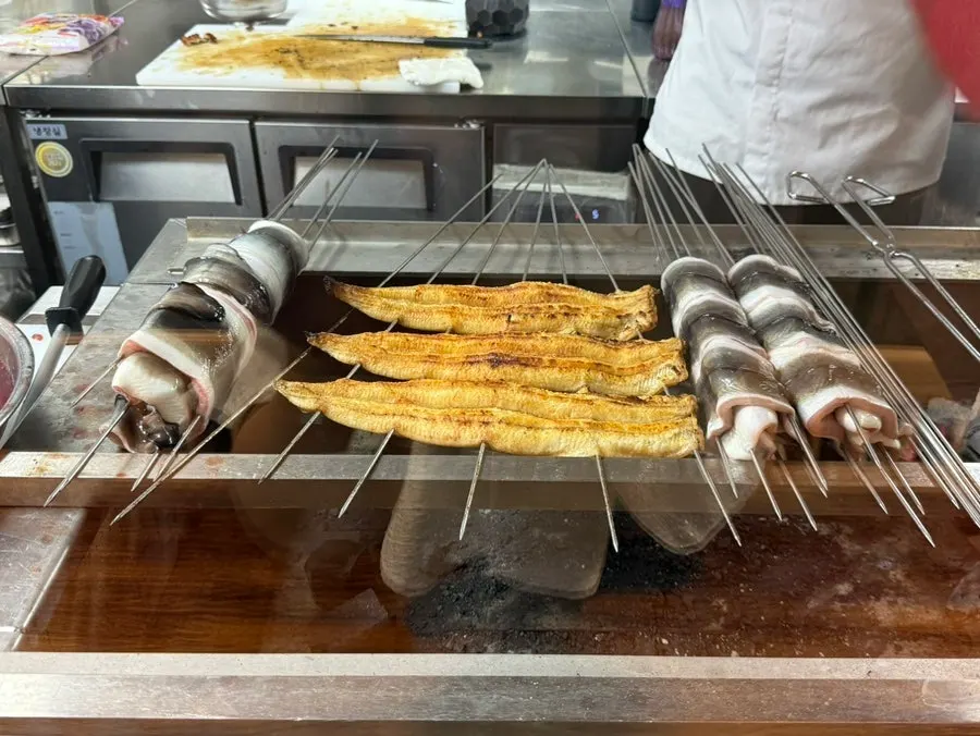 Eel being grilled in the open kitchen