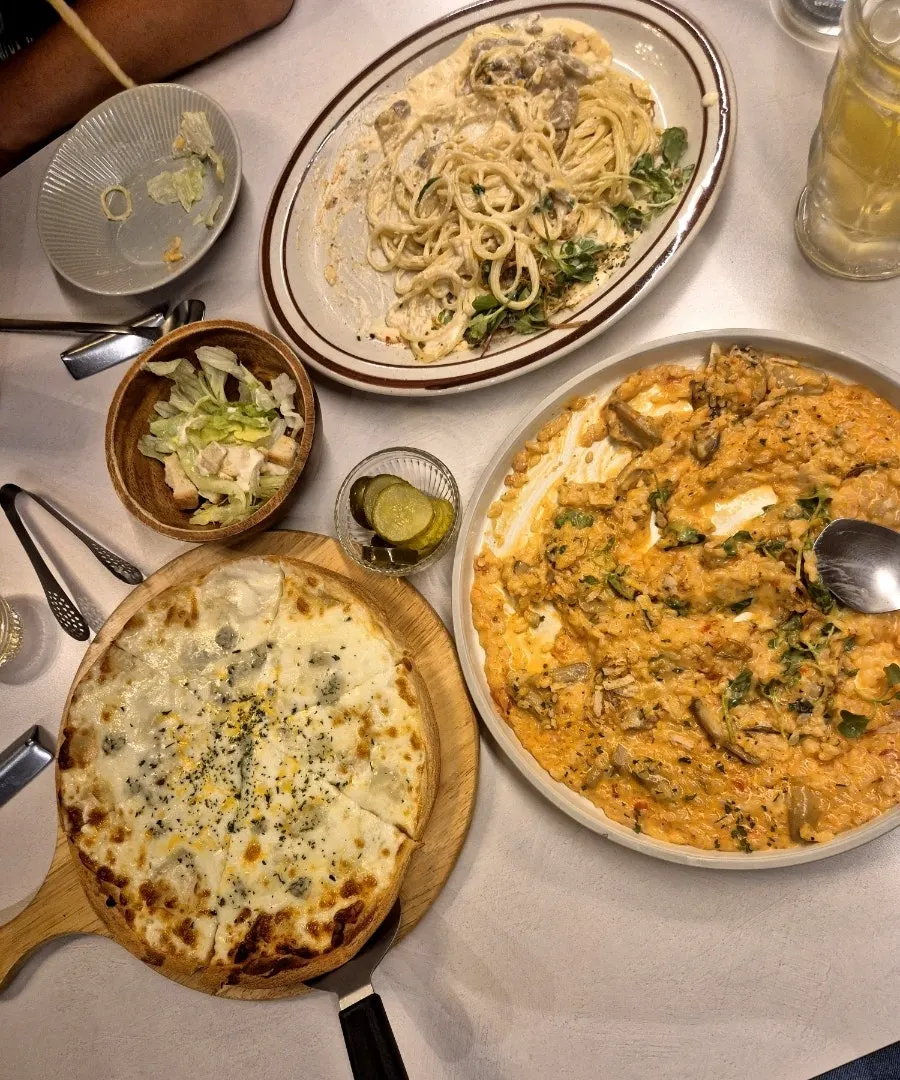 Pizza served with pasta and risotto sauces