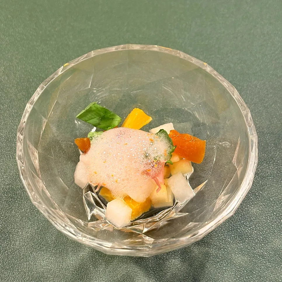 Fruit salad topped with prosciutto