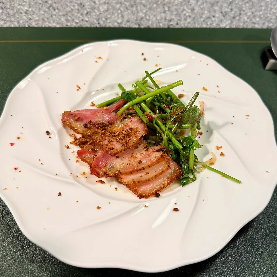 Hwajiao pork belly served with minari
