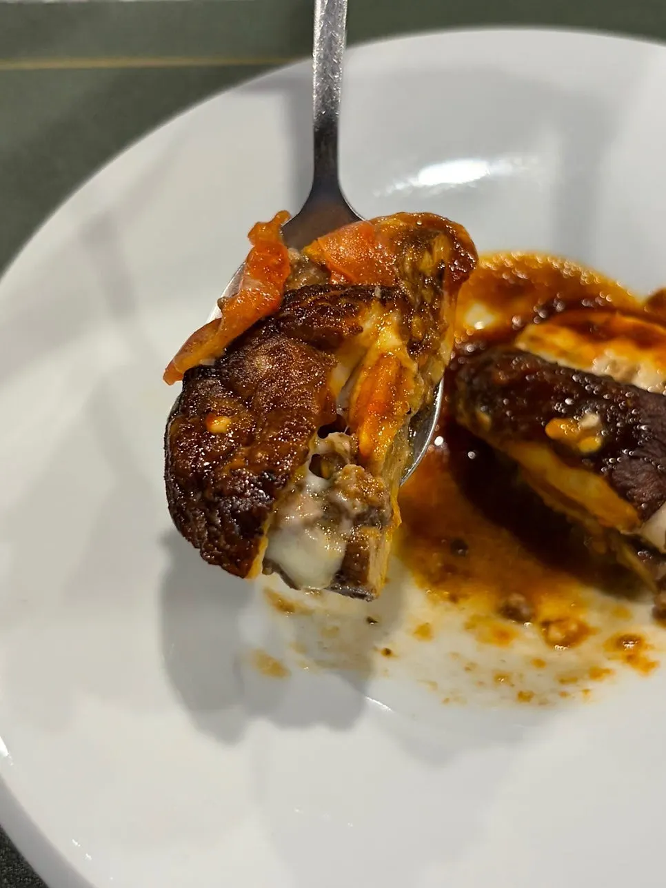A slice of shiitake lasagna with stretchy cheese