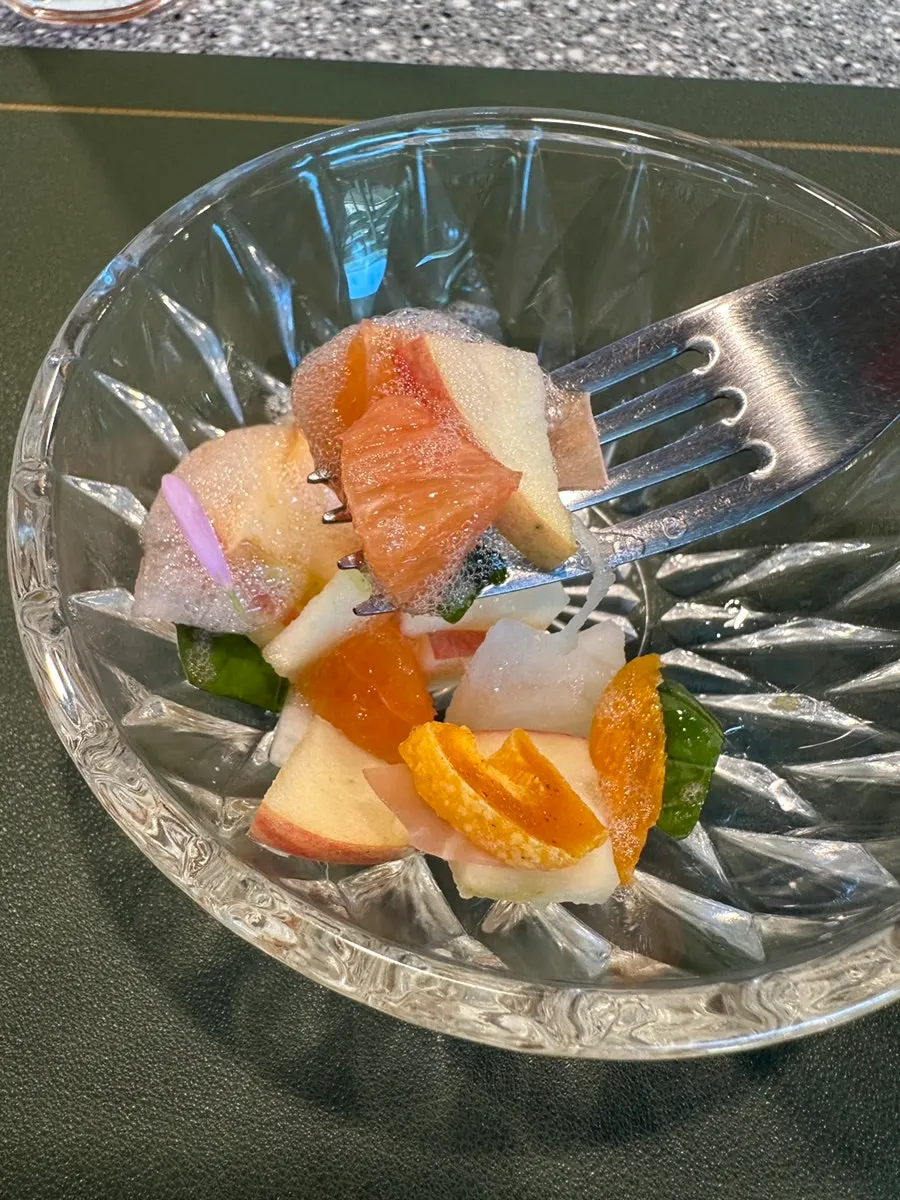 Salad topped with orange foam
