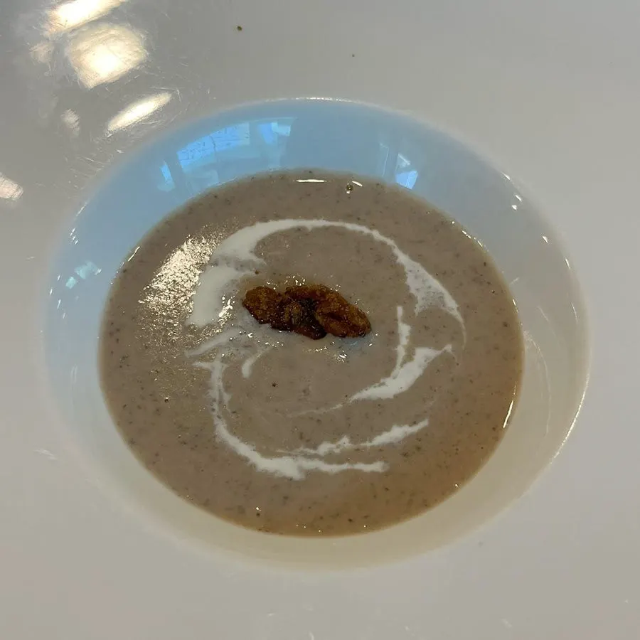 Close-up of the chestnut mushroom soup topped with fresh cream
