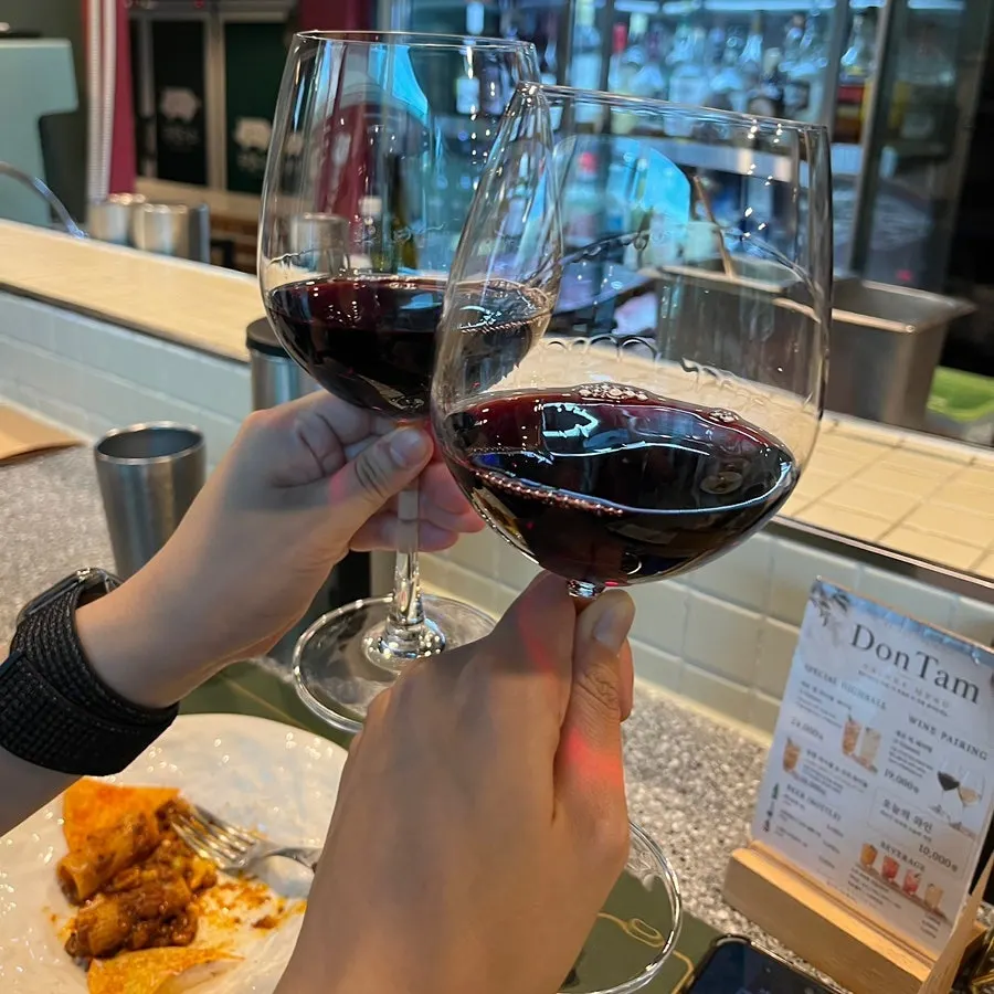 A glass of red wine served alongside the main course