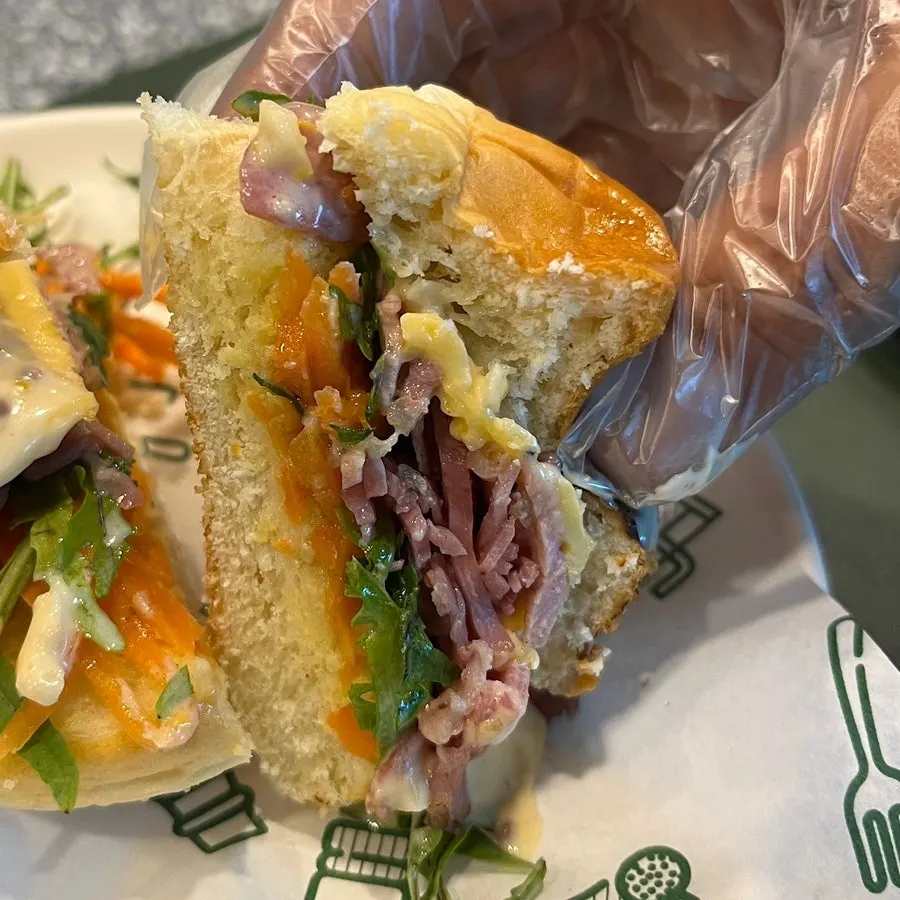 Small burger filled with jambon ham and arugula